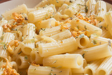Delicious plated with a recipe for pasta with macaroni with oregano, parsley, garlic, and vegan butter. Healthy food.