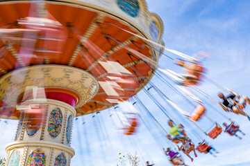 summer blurred photo of Rollercoaster against blue sky