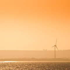 Wind turbine at dusk off the North East coast of England, United Kingdom