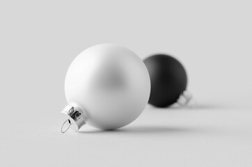 White and black matte Christmas balls mockup on a seamless grey background.