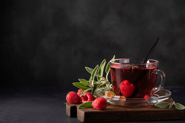hot raspberry tea with sage and honey in a glass mug