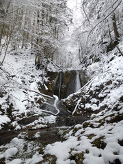 Waterfall at winter mountain tour to Seekarkreuz mountain, Bavaria, Germany