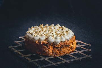Detail of gluten free almond cake, covered with mascarpone and almond pieces.