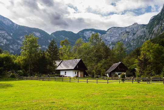 Mountain cabins in the region of Ukanc near the Lake Bohinj in the Triglav National Park in Slovenia on summer day with clouds