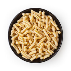 Uncooked fusilli corti bucati pasta in black bowl isolated on white background with clipping path