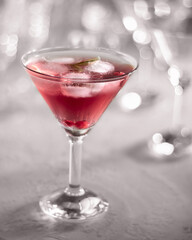 A glass of cocktail with red currants and ice