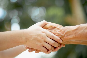old man and young man holding hand together.