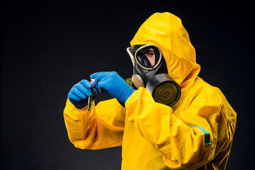 A male doctor or biologist wearing a protective suit to fight a pandemic or coronavirus. She's...