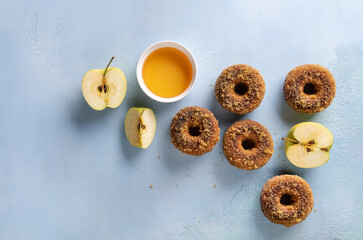 Flat lay with apple cider doughnuts on blue
