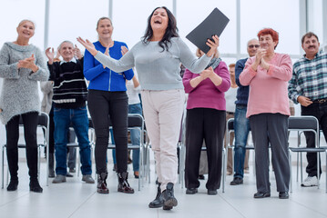 a group of mature people rejoice at their success