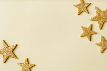 Fortuna gold color background trend of the year 2021. Christmas and New Year background with gold stars. Copy space.