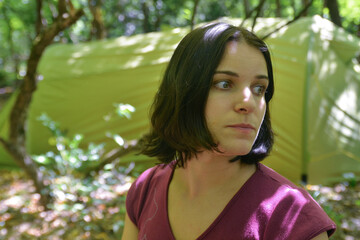 Fototapeta premium Young woman in front of the tent in the wood. Guamskoye gorge. Krasnodar Krai, Caucasus, Russia.