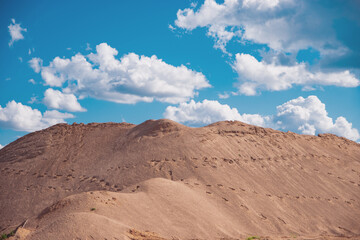 large pile of sand against the sky