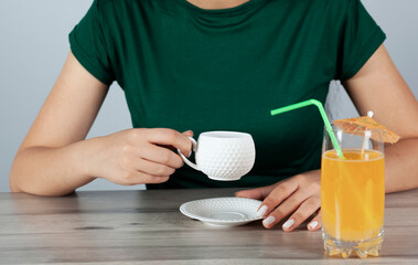  woman hand with  Orange juice in coffee