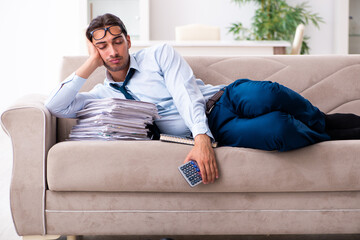 Young male businessman working at home