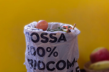 close-up of egg shells and food scraps in a bag with the inscription: "100% bio compostable bag. Trash can with organic waste. Compost concept.