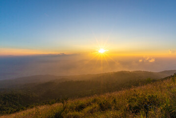 Beautiful sunset with sunstar view point from Khao Luang Sukhothai, Ramkhamhaeng National Park , Sukhothai Thailand.