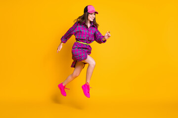 Fototapeta na wymiar Full length photo of student running empty space wear cap violet plaid outfit isolated on yellow color background