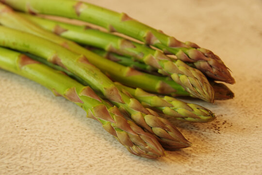 Asparagus. Bunches of green asparagus on a yellow background. Top view image. Fresh Asparagus. 