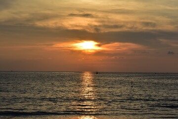beautiful sunset background with orange shade and  the reflection ,wave .The immense horizon line of  the sea at phuket  thailand