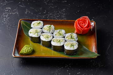 Vegetarian sushi rolls with cucumber and sesame seeds. Kappa Maki. On dark background.
