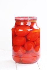 Marinated tomatoes on white table