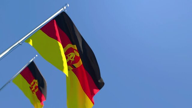 The national flag of German Democratic Republic flutters in the wind