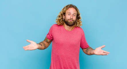 blonde man feeling puzzled and confused, unsure about the correct answer or decision, trying to...