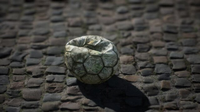 Old soccer ball in the pavement yard