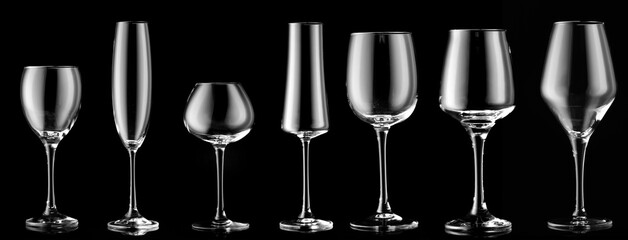 Different empty glasses on dark background