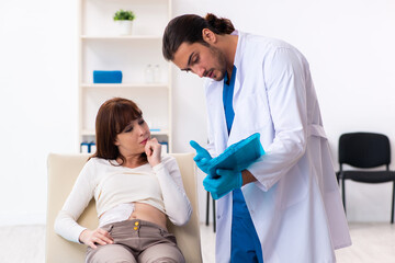 Injured young woman visiting young male doctor