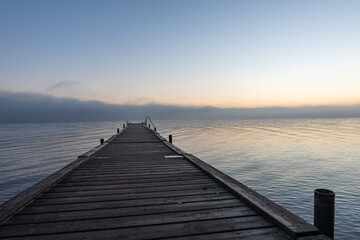 Fototapeta na wymiar grey wooden jetty in the calm sea