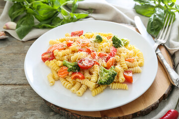Plate with tasty pasta primavera on table