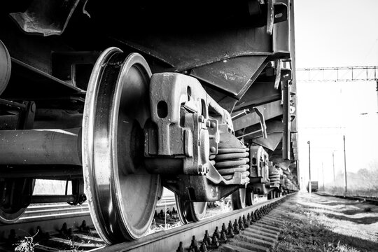 Close-up of a train wheel. Black and white photo with grainy effec