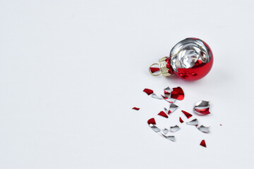 Broken Christmas ball in red on a white background. The view from the top. Broken Christmas toy