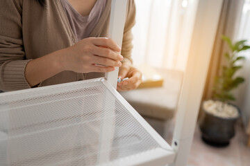 Close up women hand is putting together self assembly furniture.