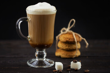coffee with cappuccino in a clear glass on the table