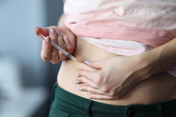 Woman gives an injection in the stomach. Stomach injections for diabetes concept