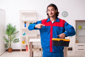 Young male carpenter working indoors