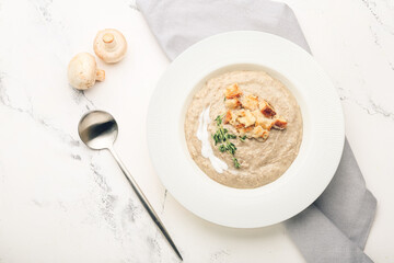 Plate of tasty cream soup on light background