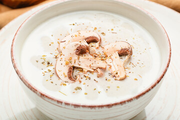Bowl of tasty mushroom cream soup, closeup