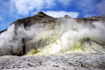 a smoking rocky volcano with steaming sulphur vents