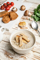 Bowl of tasty cream soup on wooden background