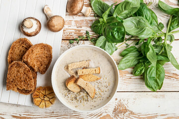 Bowl of tasty cream soup on wooden background