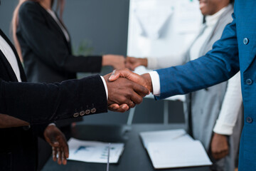 A close-up of two black men shaking hands. Investor and developer two African Americans shake hands