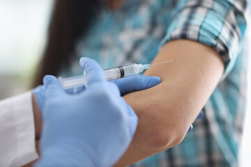Doctor injects the patient in the shoulder. Vaccinations for disease prevention concept