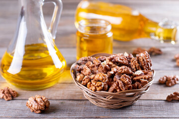 Walnut oil with nuts on a wooden table. Change traditional oil