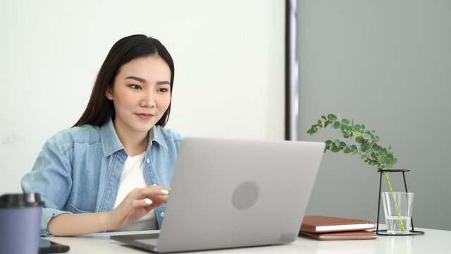 Surprised asian woman looking on laptop, Online watching a good news with internet connection.