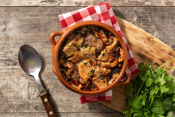 Traditional mondongo or el menudo soup on wooden table