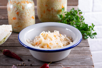 Homemade sauerkraut with carrot and spices on plate, sour cabbage